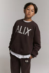 Meisjes Kids knitted world tour sweater van ALIX Mini in de kleur Warm Brown in maat 158-164.