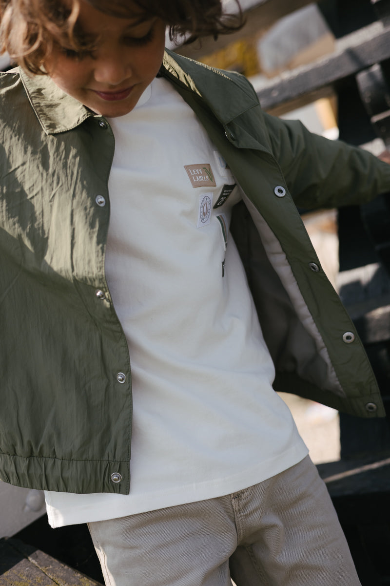 Jongens T-Shirt BANU van Little Levv in de kleur White Cream in maat 128.